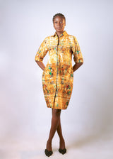 This Multicolored Cotton Shirt Dress, designed for effortless confidence and all-day comfort. Crafted from soft, breathable cotton, this knee-length shirt dress features a button-down front, a classic collar, and two convenient patch pockets at the hips. The vibrant geometric pattern a rich blend of yellow, teal green, and deep blue and adds a modern twist to a timeless silhouette.